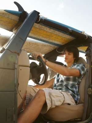 teenager-driving-jeep-with-surfboards-2025-04-05-10-23-32-utc